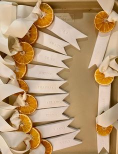 orange slices with ribbons and name tags are arranged in a rectangle on a tray