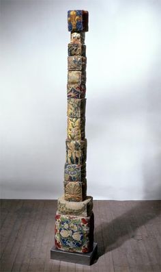 a tall sculpture made out of fabric on top of a wooden floor