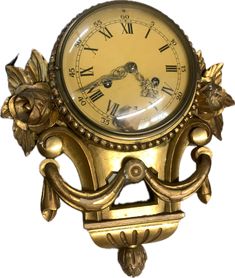 an antique clock with roman numerals and flowers