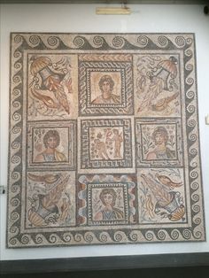 an old mosaic on display in a museum