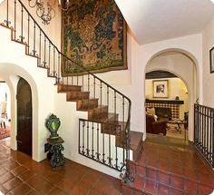 an entry way leading to a living room and dining room area with tile flooring