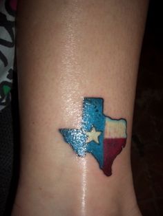 a small texas tattoo on the ankle is shown in red, white and blue colors