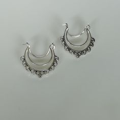 Indian style sterling silver ethnic hoops. Dimensions: 19 x 24 mm Price listed is for ONE PAIR. These earrings are made of 925 hypoallergenic sterling silver. Please note this price is for ONE PAIR only. All my pieces are sent in a gift box. I can include a personal message from you if needed You are welcome to contact me at... bhavnakwintra1956@gmail.com For more beautiful pieces from my shop, please browse 👇 TOE RINGS: https://www.etsy.com/your/shops/TheSilverGame/tools/listings/section:27020 Silver Hoop Earrings With Ear Wire, Silver Hoop Chandelier Earrings, Handmade Silver Hoop Chandelier Earrings, Silver Bohemian Hoop Earrings For Festivals, Silver Crescent Hoop Earrings With Ear Wire, Bohemian Small Hoop Silver Earrings, Silver Crescent Plug Earrings For Pierced Ears, Festive Bohemian Silver Hoop Earrings, Silver Bohemian Small Hoop Earrings