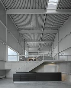 an empty building with stairs and windows