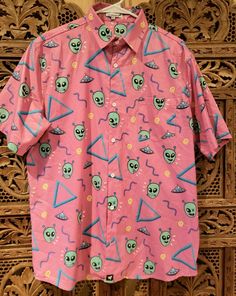 Vintage Mercury Merch "Alien"  Pink Button Down Shirt Single Stitch Sz XL.  Has 1 front breast button. Measurements 29" long 22" wide (armpit to armpit) 9.5" sleeve length  (short sleeve) Material is polyester type Shipped with USPS First Class. Pink Button-up Shirt With Graphic Print, Pink Graphic Print Button-up Shirt, Pink Graphic Print Button-up Top, Pink Retro Shirt With Relaxed Fit, Pink Printed Button-up Shirt, Fun Spring Button-up Tops, Retro Pink Printed Shirt, Fun Long Sleeve Shirt With Relaxed Fit, Fun Long Sleeve Relaxed Fit Shirt