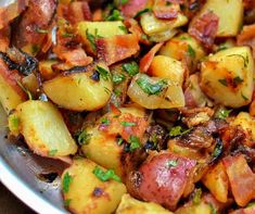 a close up of a plate of food with potatoes and herbs on it, including onions