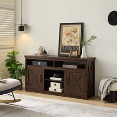 a living room scene with focus on the entertainment center and chair in the foreground