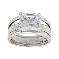 a white gold ring with a princess cut diamond in the center and two bands around it