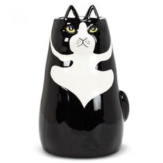 a black and white cat figurine with yellow eyes