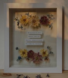 some flowers are sitting in a shadow box