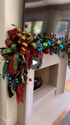 a fireplace decorated with christmas decorations and bows