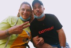 a man and woman posing for the camera with their face covered by bandannas