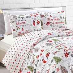 a bed with christmas themed comforters and pillows