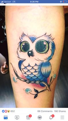 an owl with big eyes sitting on a tree branch and looking at the camera tattoo design