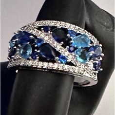 This Beautiful Silver Color Ring With Cz Sapphire Stones In Round, Pear And Oval Shape Any Questions Please Comment Below Great For Everyday, Date Night, Parties, Work, Birthday Present, Valentine’s & Christmas Blue Cubic Zirconia Rings With Diamond Accents, Blue Cubic Zirconia Promise Ring, Elegant Blue Multi-stone Crystal Ring, Blue Diamond Crystal Ring For Anniversary, Blue Multi-stone Diamond Jewelry, Dazzling Blue Jewelry For Promise Ring, Dazzling Blue Diamond Ring With Accent Stones, Blue Rings With Stones In Fine Jewelry Style, Blue Ring Jewelry For Party