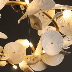 a chandelier made out of paper umbrellas hanging from the ceiling