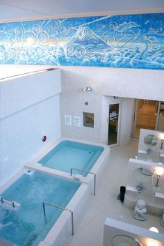 a bathroom with a jacuzzi tub, toilet and sink in the middle of it