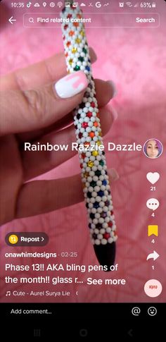 someone is holding a beaded pen in their left hand and the caption reads rainbow razzle dazzle