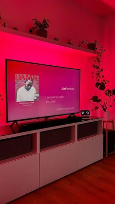 a flat screen tv sitting on top of a entertainment center