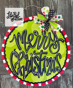 a green christmas ornament with the words merry christmas in black lettering on it