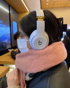 a woman wearing headphones and a scarf