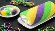 a colorful cake on a plate next to beads