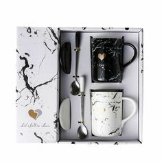 an assortment of kitchen utensils in a white box with black marbled design