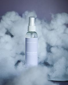 a bottle of deodorant surrounded by clouds