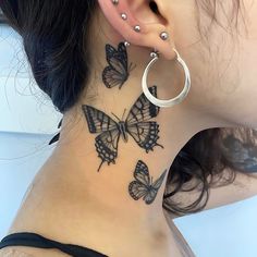 a woman's neck with butterfly tattoos on her left side and behind the ear