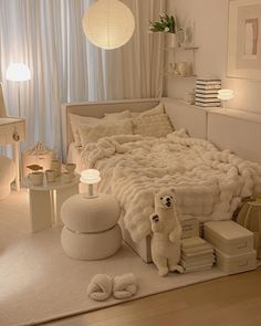 a white bedroom with teddy bears on the bed and other items in front of it