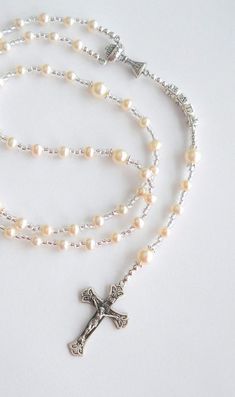 Find this item at a lower price at VioletsAndVows.com!PLEASE READ THE ENTIRE LISTING AND VIEW ALL PHOTOS, as most --if not all--of your questions are answered in those areas. This beautiful rosary measures approximately 18-19+" (circumference is approximately 21-22"), depending on the length of the name, and was handcrafted with beautiful and genuine freshwater pearls and accented with sparkly glass seed beads and sterling silver accents. The Our Father beads are framed by sterling silver daisy- White Jewelry For Confirmation On Mother's Day, Adjustable Silver Rosary For Mother's Day, Handmade Spiritual Jewelry For Confirmation, Handmade White Jewelry For Confirmation, White Rosary, Baby Dedication Gifts, Beautiful Rosary, Goddaughter Gifts, Pearl Rosary