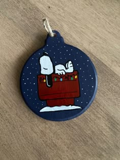 a wooden ornament with snoopy on it