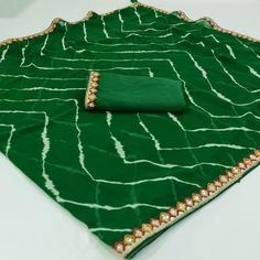 Green colored saree is made from georgette fabric which is highlighted with beautiful printed with sequince embroidered lace border work as shown. comes along unstitched banglori silk blouse piece which you can customise as per your design/style. Occasion - You can wear this saree for casual and daily and ideal for any fashionista. Note:- The actual product may differ slightly in color and design from the one illustrated in the images when compared with computer or mobile screen. Measurements: S Green Georgette Dupatta With Printed Border, Green Semi-stitched Blouse Piece With Printed Border, Semi-stitched Green Blouse Piece With Printed Border, Green Georgette Saree With Embroidered Border, Green Blouse Piece With Embroidered Border For Diwali, Green Saree With Embroidered Border For Diwali, Festive Green Blouse Piece With Embroidered Border, Green Embroidered Saree For Diwali, Diwali Green Saree With Embroidered Border