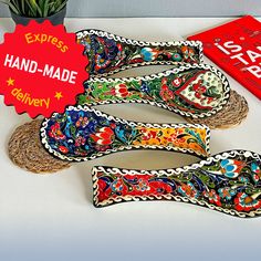 four pairs of handmade espadrills sitting on top of a table next to a plant