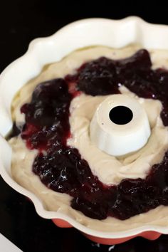 a blueberry pie in a white pan on top of a stove