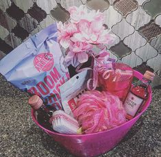 a pink basket filled with lots of different items