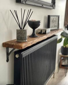 a radiator with candles and pictures on the wall