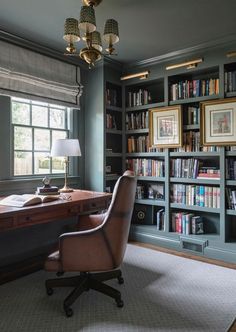 a chair sitting in front of a desk next to a book shelf filled with books