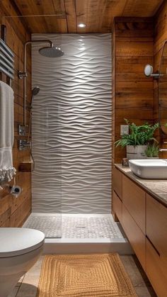 a bathroom with wood paneling and a white toilet sitting next to a walk in shower