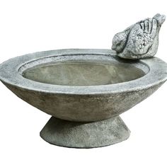 a stone bird bath with a hand resting on it's head in front of a white background