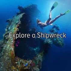 a person is swimming in the water near a large ship that has scuba equipment on it