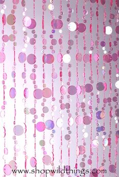 pink and white polka dot curtains hanging from the ceiling