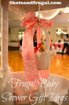 a baby shower gift basket with pink ribbon