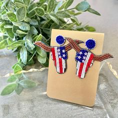 two red, white and blue beaded bird earrings