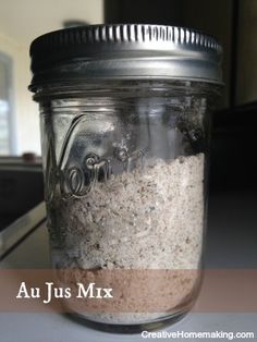 a jar filled with lots of sand sitting on top of a counter