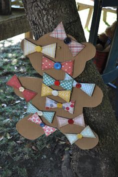 a paper cut out of a teddy bear hanging from a tree