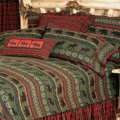 a bed with red and green plaid comforter on it's side, next to a wooden headboard