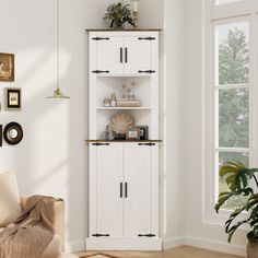 a living room filled with furniture next to a white wall mounted cabinet and potted plant