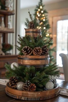 a christmas tree made out of wine barrels and pine cones on a dining room table