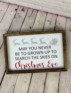 a sign that says, may you never be to grown up to search the skies on christmas eve